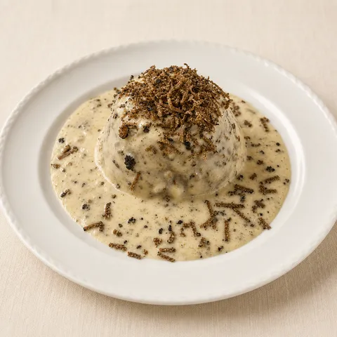 Beef and aubergine flan with parmesan fondue and fresh truffle.