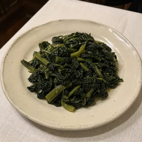 Leafy greens cooked and dressed with olive oil.