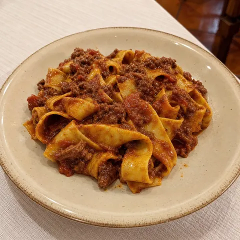 Pappardelle dressed with red wild boar ragù.