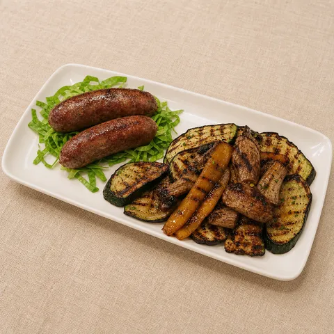 Umbrian sausages and grilled vegetables on a rectangular plate.